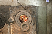 Top view of wood-fired cooker with view of fire through hob