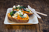 Stuffed sweet potatoes with spinach, red onions, couscous, feta cheese and coriander