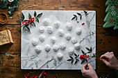 Mexican wedding biscuits with icing sugar on a marble slab