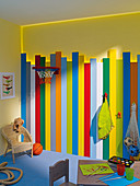Colourful planks against wall with indirect lighting