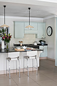 Island counter in kitchen in shades of pastel green and cream