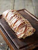 Raw pork wrapped in Parma ham