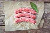 Raw salsiccia sausages with fennel on parchment paper