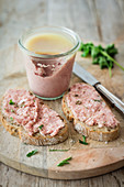 Homemade raw minced pork and onion spread on bread and in a glass