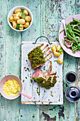 A rack of lamb with a herb crust, potatoes and bean salad