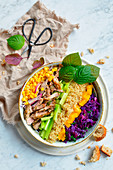 A healthy salad bowl with quinoa, chicken and vegetables