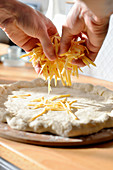 A pizza base topped with cheese