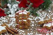 A stack of cinnamon stars tied with string with sugar nibs