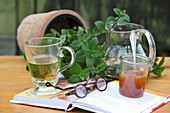 Mint tea in a glass, with fresh leaves and honey