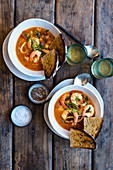 Fish and seafood soup with chorizo, tomatoes and toasted bread