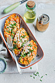 Baked sweet potatoes with cheese and chives