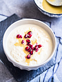 Cream of cauliflower soup with pomegranate seeds and tahina sauce
