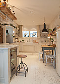 Large white country-house kitchen with dining area
