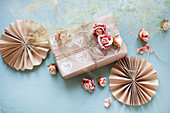 Paper rosettes, gift box and roses