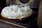 Lemon tart with a meringue dome in the oven