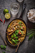 Beef rendang curry, slowly cooked with lemon grass, lime leaves, spices and coconut cream, garnished with crispy aubergine and fresh coriander