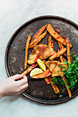 Turkey escalope with sweet potato fries, chervil and lemon