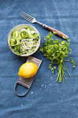 Grated cucumber, onion shoots, lemon with a grater and chervil