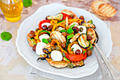 Grilled vegetable salad with olives capers and small fresh mozzarella