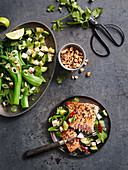 Fried salmon with sesame seeds served with bok choy with peanuts, chilli, tofu and cucumber