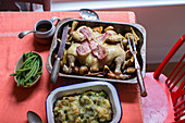 Butterfly chicken with bacon and potatoes served with broccoli gratin