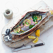 Grilled trout wrapped in newspaper