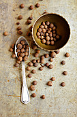 Allspice grains in a bowl and on a spoon