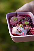 Pickled herring with beetroot and spring onions