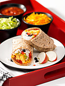 A burrito with egg, rice and beans