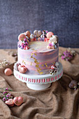 A berry cake with white chocolate and macaroons