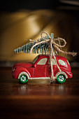 Christmas arrangement of toy car with Christmas tree on roof