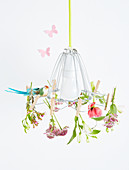 Flowers clipped to lampshade with clothes pegs