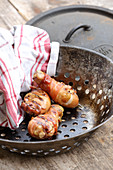 Grilled drumsticks wrapped in bacon