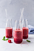 Bottles of raspberry smoothies
