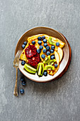 Crepes with fresh fruit on a plate (seen from above)