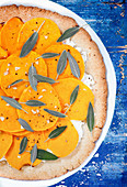 Vegetarian pizza with butternut squash slices, ricotta cheese and sage leaves