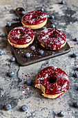Doughnuts with blueberry glaze and glitter powder