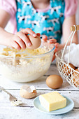 Child Cracking Eggs into a Mixing Bowl