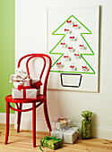 Chair with gifts in front of Christmas tree-shaped advent calendar