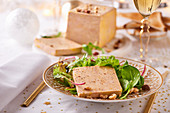 Goose liver pate with salad garnish and nuts (Christmas)