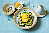 A steamed orange medley with pumpkin seeds