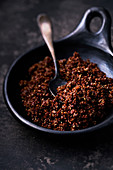 Red cooked Quinoa with spoon