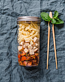 Casarecce with dates, smoked tofu and tomatoes in a jar