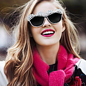 A young woman with lipstick and sunglasses