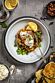 Broad bean fritters with herbs, bacon and goat's cream cheese