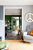 View into hallway and kitchen with walls of various colours