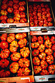 Beefsteak tomatoes in crates at a market