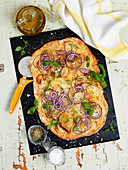 Flatbread with potatoes, red onions, olive oil, basil, salt and spices