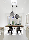 Industrial-style table and chairs in white dining room