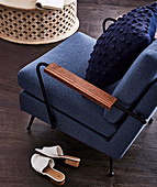 Upholstered blue armchair with pillows